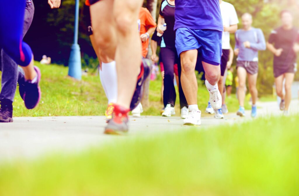 Group of unidentified marathon racers running, detail on legs