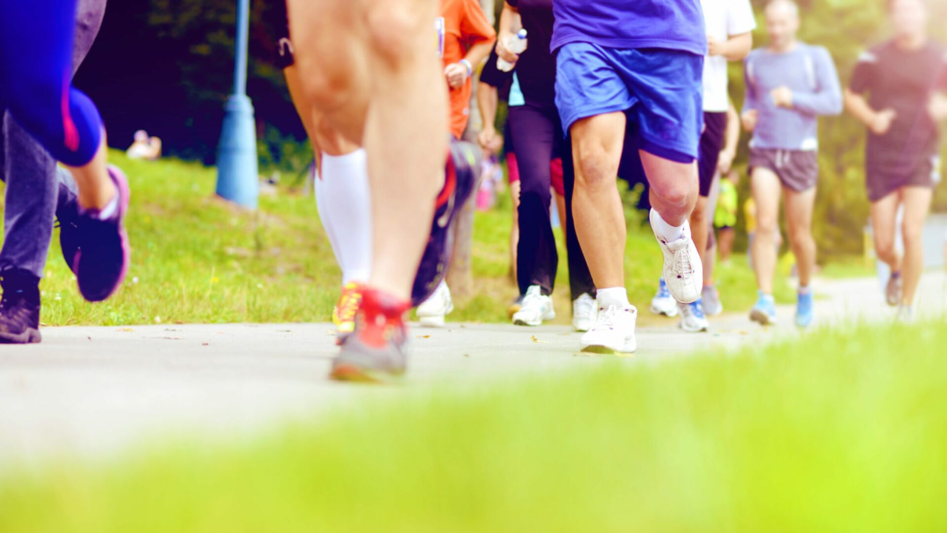 Group of unidentified marathon racers running, detail on legs